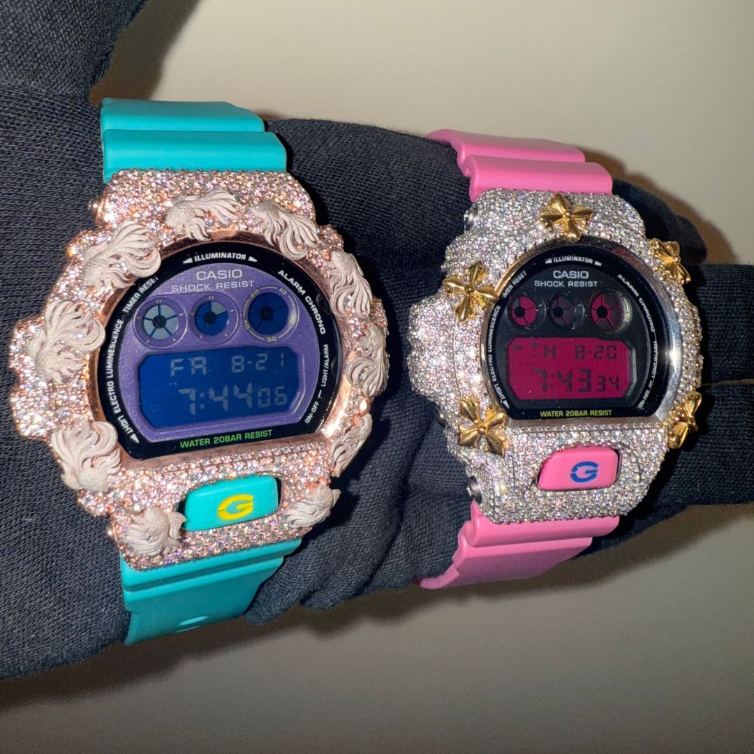Turquoise and pink G-Shock watches, side by side on the wrist